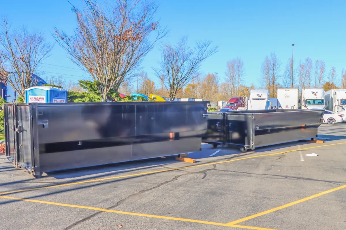 Professional dumpster rental service with roll-off container on residential driveway in Moscow
